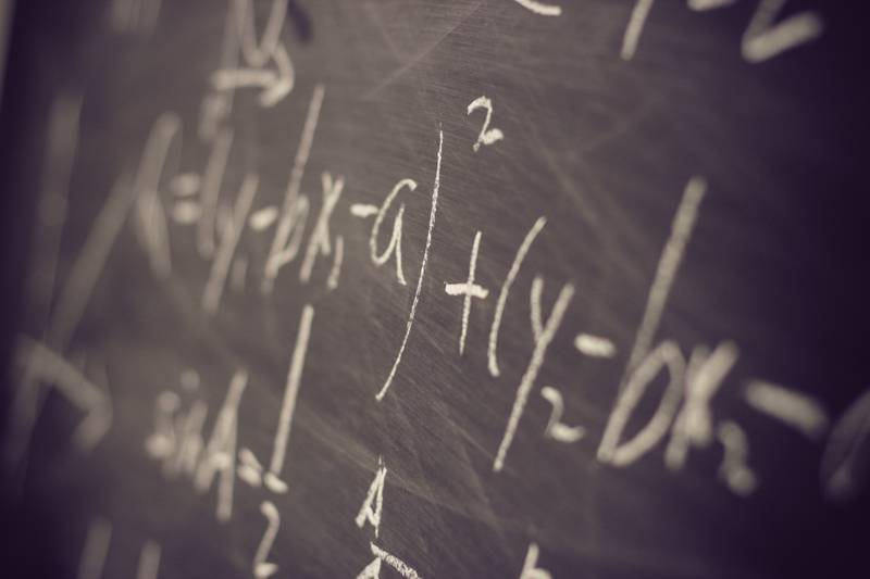 chalkboard with complex equations on it
