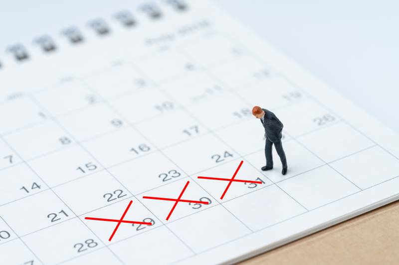 calendar with a figurine standing on it looking at three days crossed off